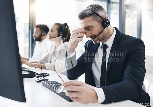 Image of Call center, customer service and man with headache, stress and tired of working in office. Burnout, crm and frustrated male telemarketing consultant in customer support on call with difficult client