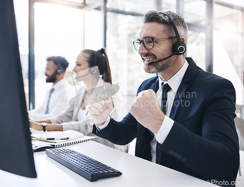 Image of Success, call center and winner with businessman at computer for consulting, telemarketing or customer support. Wow, deal and goals with employee in office for communication, contact us and crm help