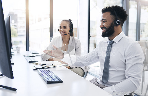 Image of Black man, crm consultant and customer support service employee training a colleague at work with a smile. Digital call center staff, online telemarketing business and office worker at desk computer