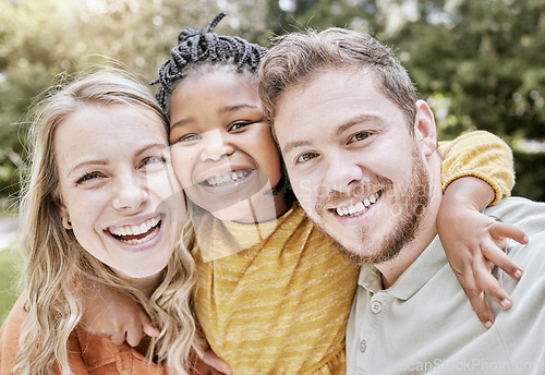 Image of Happy, interracial family and smile portrait of a mother, girl and father with bonding in nature. Diversity, love and adoption care of a mom, kid and man hug together with youth happiness outdoor