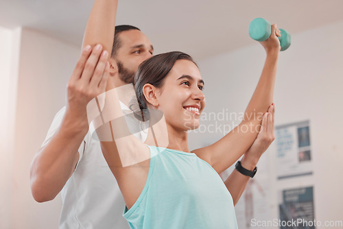 Image of Physical therapy, dumbbell and woman exercise during recovery with physical therapist, happy and hope at clinic. Physiotherapy, support and help from physiotherapist in consultation room for patient