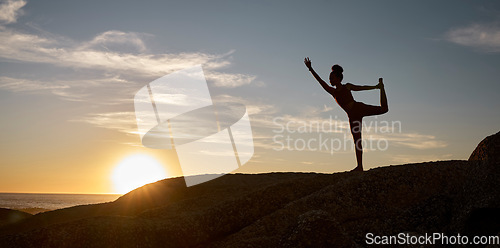 Image of Woman, silhouette or yoga on sunset beach rocks in relax fitness, training and exercise for mental health, body mobility or wellness. Yogi, pilates or workout at sunrise for zen stretching by ocean