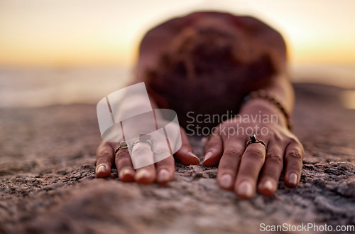 Image of Fitness, woman meditation or yoga hands on sand floor stretching at the beach, ocean or sea with sunset in background for wellness, exercise or zen. Girl, health for chakra focus, mindset or pilates