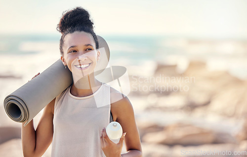 Image of Happy black woman, fitness and smile for yoga in preparation for training, exercise or workout at the beach. Female smiling in spiritual wellness holding sports mat for calm, zen and exercising day