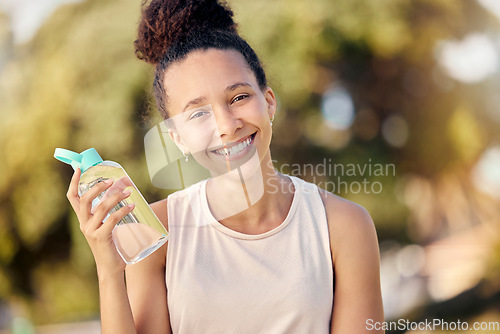 Image of Water bottle, fitness and nature of black woman in portrait for outdoor exercise, wellness and healthy diet lifestyle in park or forest. Trees bokeh, workout and sports girl with drinking water gear