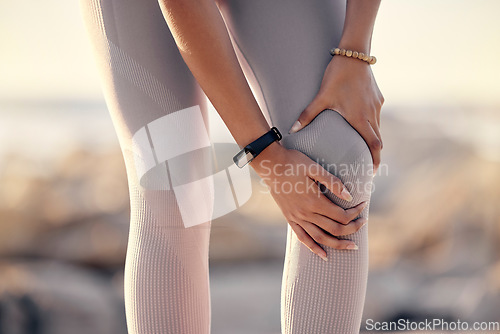 Image of Knee injury, beach and hands of woman hurt from workout accident, exercise or sports cardio for athlete fitness. Medical emergency, healthcare and legs of training runner in pain after nature running