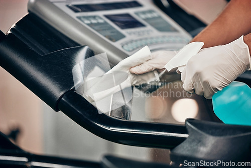 Image of Hands, spray bottle and covid cleaning in gym for healthcare compliance, medical safety and global bacteria virus stop. Zoom, fitness or training center in covid 19 hygiene management for cleaner man