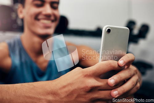 Image of Zoom, fitness or happy black man with phone in gym for networking, social media app or communication. Hands, smile or man with smartphone, tech or success contact us website search in exercise studio