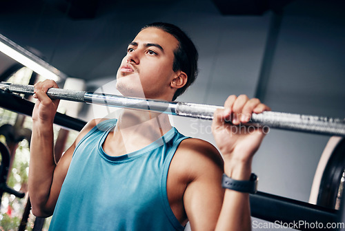 Image of Fitness, man and weightlifting barbell at the gym for heavy workout, training or intense sports exercise. Male body builder lifting weights for strength, muscle and endurance for strong arms indoors