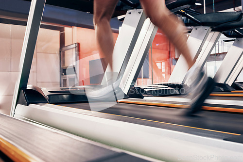 Image of Fitness, treadmill with man running on machine for exercise, cardio training and workout for cardiovascular and heart health. Legs of athlete with energy, speed and commitment for a fast speed run