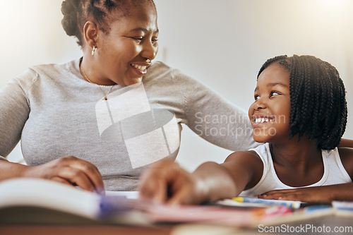 Image of Mother with young girl, learning with books in home and studying for test in Kenya. Homeschooling education, happy child writing homework and mama helping daughter with knowledge development