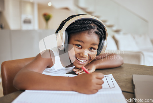 Image of Education, elearning and headphones of african child listening to audio translation, language learning and writing notes in book. Black girl kid at home with e learning, online education and portrait