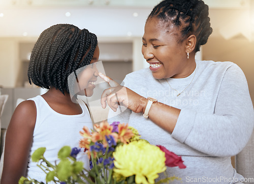 Image of Love, mother and girl smile, happy and together for bonding, loving and happiness together. Mama, daughter and black family being playful, caring and quality time being cheerful in home with flowers.