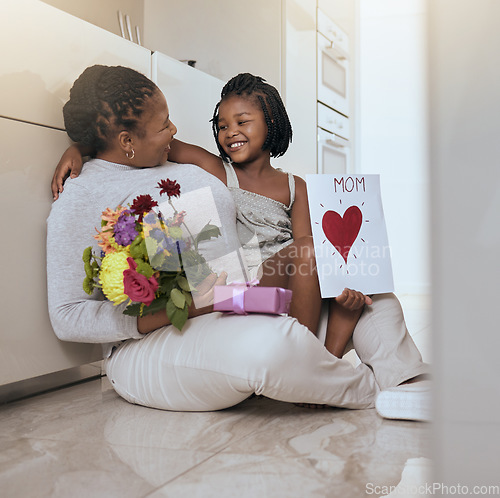 Image of Mother, child and mothers day card and gift with flowers as a gift for loving mom at home. Family, children and daughter with present for love, care and affection for female parent with note