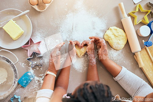 Image of Black woman, child hands or kitchen baking of heart shape pastry, house cookies or dessert biscuit scone in family home. Top view, mother or girl cooking food in help, support or learning cake recipe
