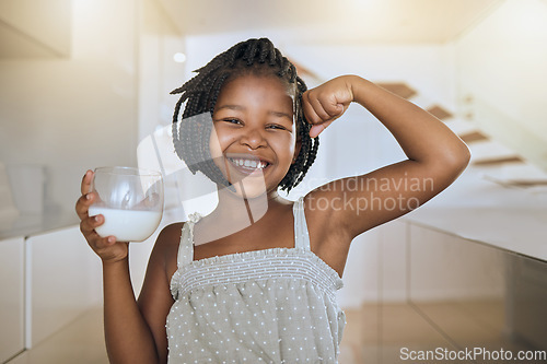 Image of Milk, portrait and African girl with muscle from healthy drink for energy, growth and nutrition in the kitchen. Happy, smile and child flexing muscles from calcium in a glass and care for health
