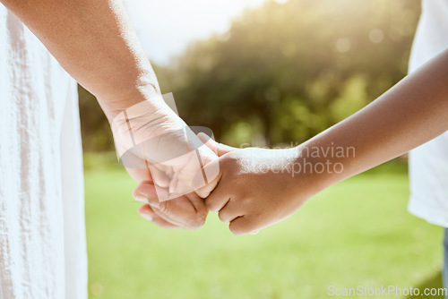 Image of Park, family and parent holding hands with child bonding together enjoying nature and outdoors. Summer, love and hands of young kid with adult bonding, carefree on weekend, holiday and vacation