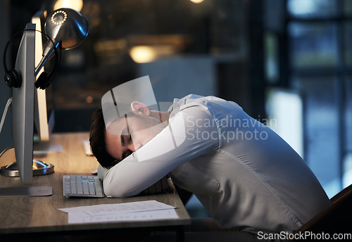 Image of Man, burnout and sleep in call center office, overworked from working at crm compliance consulting company. Businessman, sleeping and mental health stress from corporate document planning online