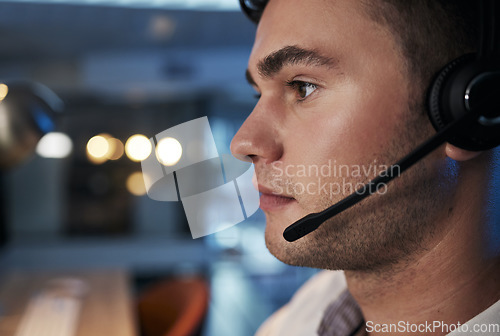 Image of Call center, night and face of man with microphone for consulting for customer service, telemarketing and sales in an office. Male working in CRM, contact us and telecom business for support and help