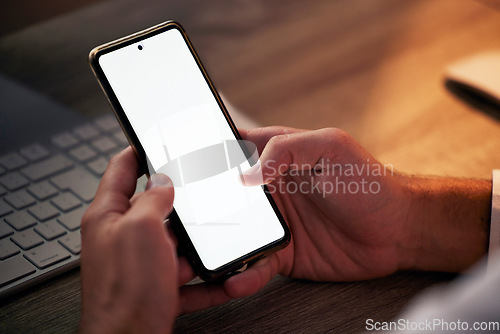 Image of Hands, phone and mock up in night office for marketing or advertising. Mockup space, tech and man networking on 5g mobile, social media or texting online, checking email or scrolling on smartphone.