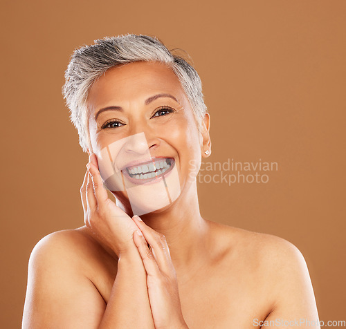 Image of Portrait, beauty and skincare with a mature woman in studio on a brown background for natural treatment. Face, luxury and wellness with a senior female posing to promote a skin antiaging product