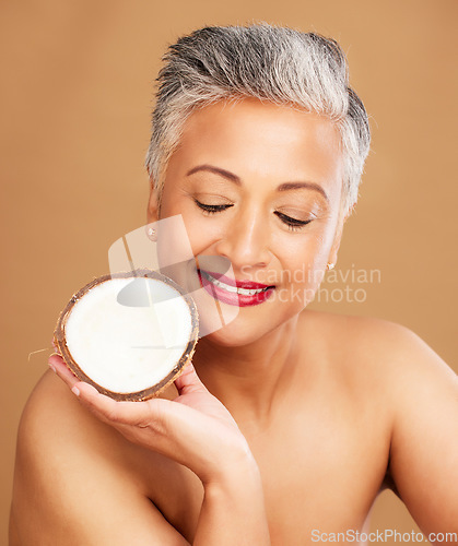 Image of Beauty, coconut and skincare with woman in natural cosmetic product advertising against studio background. Healthy skin, fresh and clean with organic cosmetics, face and body care for antiaging.