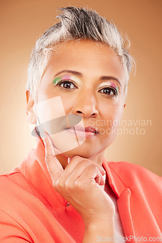 Image of Makeup, creative and senior woman with fashion, beauty and designer luxury against a brown studio background. Stylish, retirement and portrait of elderly model with an idea for cosmetics and style