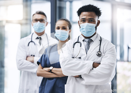 Image of Face mask, team and portrait of medical doctors standing in the hallway or corridor of a hospital. Teamwork, collaboration and group of healthcare employees ready for a covid consultation in a clinic