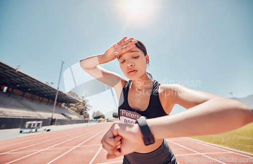 Image of Woman, tired or smart watch check on running track fitness, workout or training for sprint marathon, training challenge or race event. Stress, sweating or exhausted sports runner with speed time tech