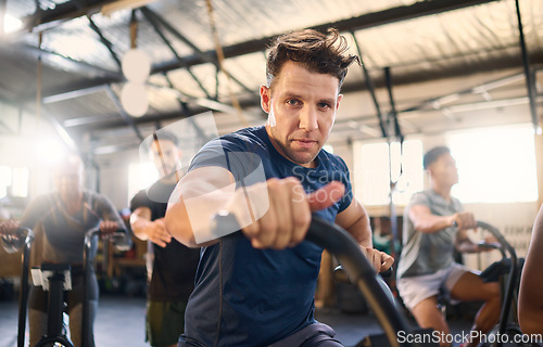 Image of Bike, class and exercise man portrait with cycling training, wellness and fitness gym group. Athlete with motivation doing a bicycle, sports and spinning workout at a health cub or studio with people