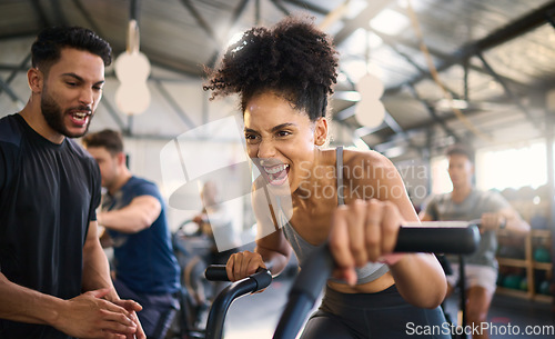 Image of Gym, fitness and woman on bike with personal trainer for motivation, support and power workout, cheering and clapping hands. Coach, black woman and cycling exercise at sport center, sweat and energy