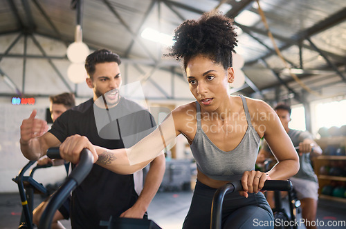 Image of Exercise bike, motivation and personal trainer with a black woman in gym for exercise or fitness. Wellness, training and cycling with a female and coach working together in a health or wellness club