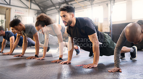 Image of Fitness, gym with men and women doing plank, strong and exercise for muscle, cardio and endurance in workout class. Health, wellness and diversity, body training and healthy active challenge.