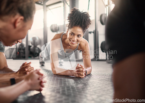 Image of Happy black woman, group and plank in gym for health, fitness and wellness with strong core on floor. Friends workout, abdominal exercise and training collaboration with smile, support and diversity