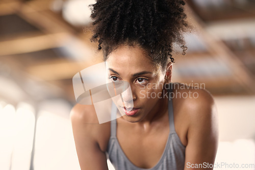 Image of Tired, fitness and woman after a gym sport, workout and training exercise run in a wellness club. Breathe recovery of an athlete sweating from sports, running cardio and strong runner jog for health