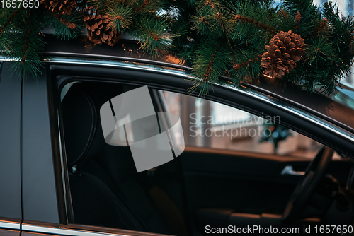 Image of Car with christmas tree on roof