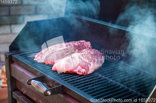 Image of Pork meat steaks on the grill