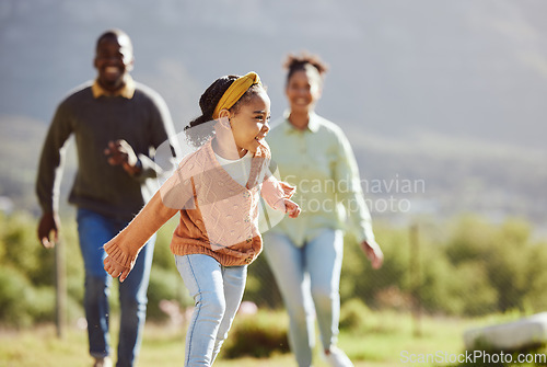 Image of Black family, fun child and parents running, chasing and enjoy bonding quality time with youth kid on countryside vacation. Love, peace and freedom for happy girl, father and mother playing outdoor