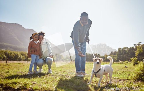 Image of Dog, walking and family relax together in nature park enviroment. Black family, pet and father walk puppy in garden with mother and child for freedom, happiness and animal care on countryside field