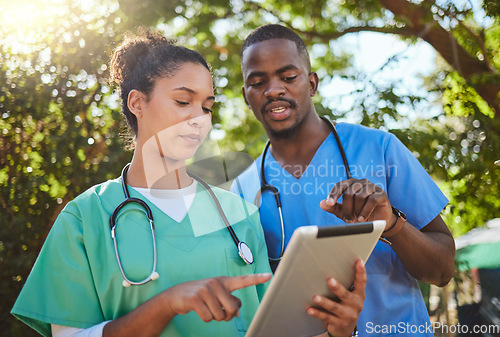 Image of Medical collaboration, nurse and doctor with tablet consulting exam results of patient healthcare. Clinic employees, hospital appointment and a digital report. Health, medicine discussion and talking