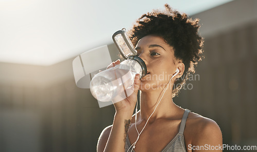 Image of Fitness, drinking water and black woman listening to music for workout motivation, wellness and healthy lifestyle in morning city. Sports, runner girl outdoor with water bottle and exercise audio