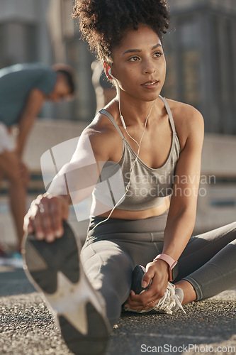 Image of Black woman, stretching legs and streaming audio yoga fitness podcast before run. Cardio training, healthy lifestyle and listening to music for motivation, peace and relax in workout on city street