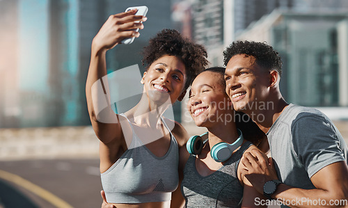 Image of Phone, selfie and fitness with a man and woman sports group taking a photograph together in the city. Health, teamwork and mobile with an athlete group posing for a picture in an urban town