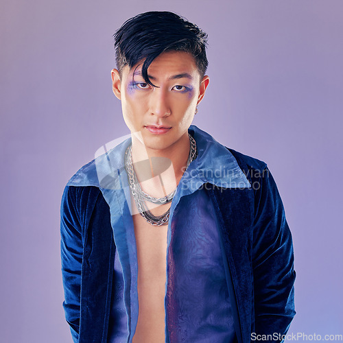 Image of Art, purple and creative portrait of man with makeup, serious face and self expression. Futuristic disco funk style fashion, male model from Japan and artistic future beauty on studio background.