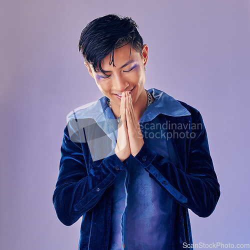 Image of Man, fashion makeup or punk rock hands in thank you, welcome or Japanese greeting on creative purple background studio. Smile, happy or artistic musician cosmetics, vintage clothes or prayer gesture
