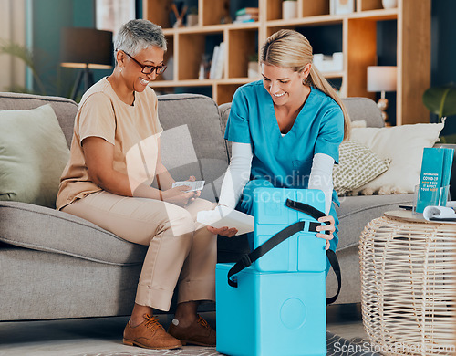 Image of Doctor, senior woman and home with medicine, box or delivery for healthcare, wellness or consulting on sofa. Patient, smile or medical conversation with nurse in living room at house for health pills