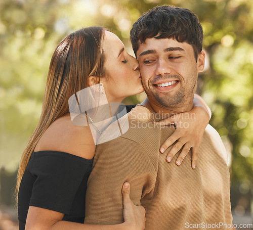 Image of Happy couple, love and kiss on cheek outdoor in nature park for vacation, adventure and quality time together in summer. Commitment, security and fresh air for healthy marriage with a man and woman