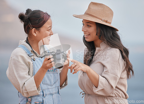 Image of Photography, happy and friends with a camera for holiday in nature of Mexico together. Smile, travel and photographer with memory on vintage camera with a woman by the sea or ocean for vacation