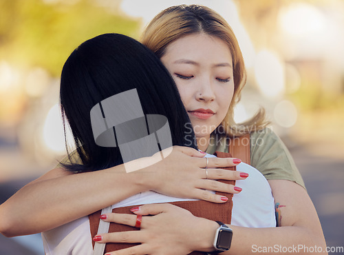 Image of Woman, friends and love hug in city outdoors together for sorry, support and lesbian couple forgive in street. Asian people, friendship and emotional hugging for grief or sadness in urban city street