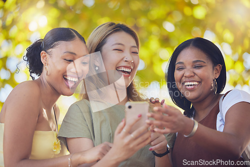 Image of Women, friends and happy phone social media with funny meme, news or online gossip in Los Angeles. Comic, fun and interracial people bond with social network communication for laughing